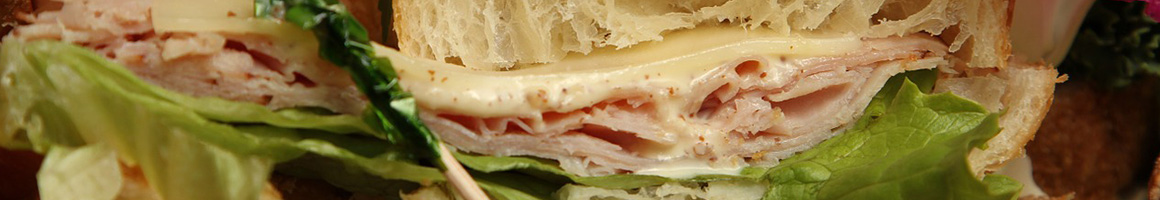 Eating Deli Sandwich at Eastern & Main Market - Deli restaurant in St Johnsbury, VT.